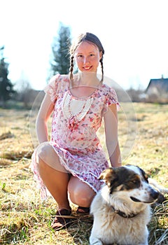 Beautiful woman in a sunshine with a dog