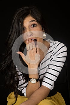 Beautiful woman with a surprised expression sitting down