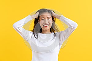 Beautiful woman surprised facial expression after seeing shocking, amaze deal isolated on yellow background. Studio shot
