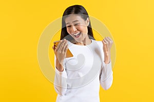 Beautiful woman surprised facial expression after seeing shocking, amaze deal isolated on yellow background. Studio shot