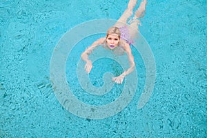 A beautiful woman swimming in the pool. View from above. A shot from the air. View from above.