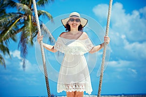 Beautiful woman swinging on a Tropical beach, Koh Phangan island. Thailand.