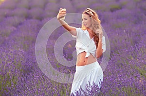 Beautiful woman take a photo in the lavender field