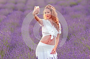 Beautiful woman take a selfie with her phone in the lavender field