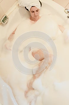 Beautiful woman takes bubble bath