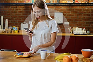 Beautiful woman takes picture of her breakfast