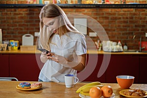 Beautiful woman takes picture of her breakfast