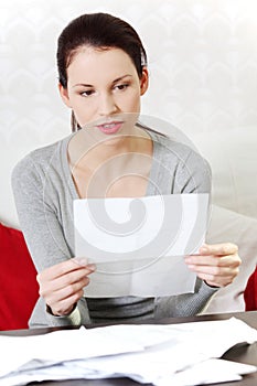 Beautiful woman taking a look at documents. photo