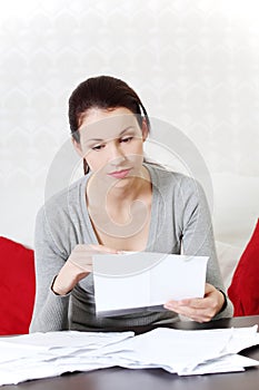 Beautiful woman taking a look at documents. photo