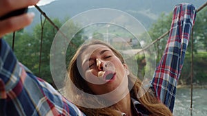 Beautiful woman taking photo selfie using phone at mountains nature landscape.