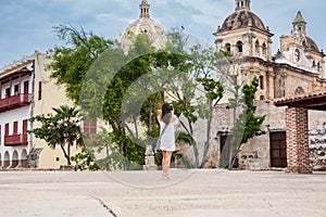 Beautiful woman taking pictures with her cellphone at the walls surrounding the colonial city of Cartagena de Indias photo