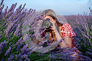Beautiful woman taking pictures outdoors in a lavender field.