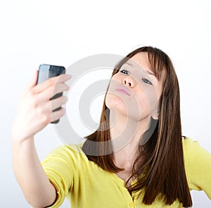 Beautiful woman taking selfies against white background