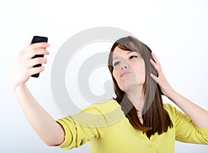 Beautiful woman taking selfies against white background