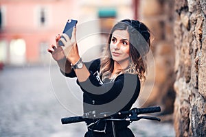 Beautiful woman taking selfies on city streets