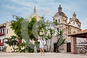 Beautiful woman taking selfies at the walls surrounding the colonial city of Cartagena de Indias