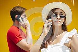 Beautiful woman talking on the phone with boyfriends in summer