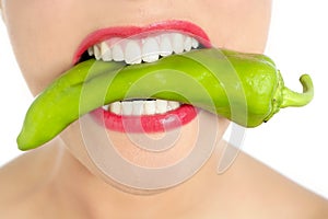Beautiful woman teeth eating green pepper