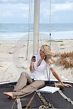 Beautiful Woman Texting On Boat At The Beach