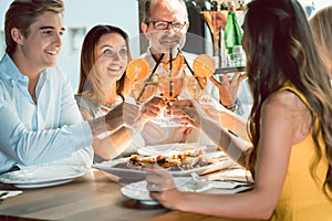 Beautiful woman toasting with her boyfriend and her best friends