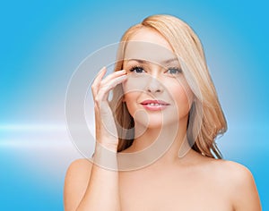 Beautiful woman touching her eye area