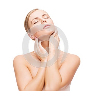 Beautiful woman touching her face with closed eyes