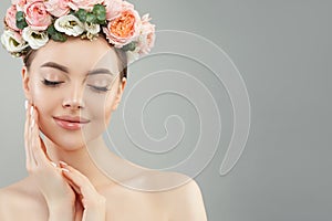 Beautiful woman touching her face her hand. Pretty candid girl with flowers. Facial treatment, face lifting, anti aging