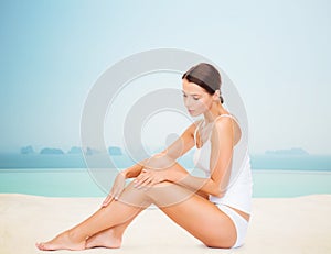 Beautiful woman touching her legs