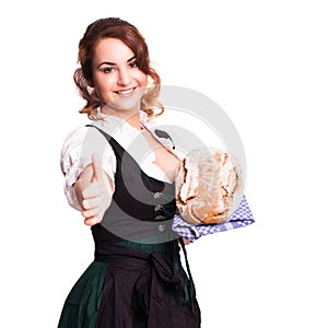 Beautiful woman in a traditional bavarian dirndl a bread