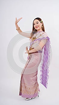 Beautiful woman with traditional thai costume posing thai dance and smiling isolated on white background , Thailand traditional
