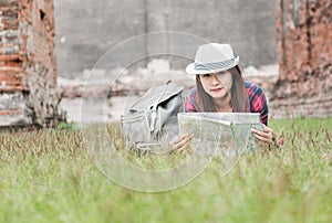 Beautiful woman traveler holding location map in hands