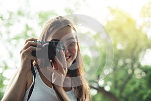 Beautiful woman traveler in white vest shirt taking photo.