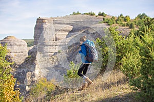 Beautiful woman traveling in autumn mountains