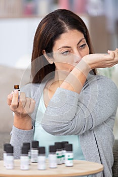 beautiful woman trying out essential oils