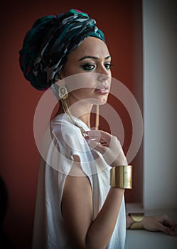 Beautiful woman in a turban.Young beautiful woman with turban and golden accessories