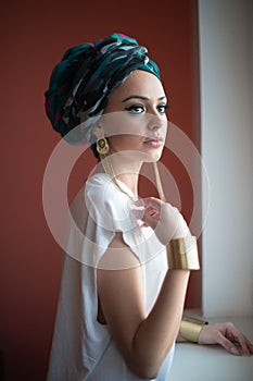Beautiful woman in a turban.Young beautiful woman with turban and golden accessories