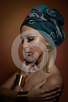 Beautiful woman in a turban.Young beautiful woman with turban and golden accessories
