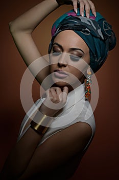 Beautiful woman in a turban.Young beautiful woman with turban and golden accessories