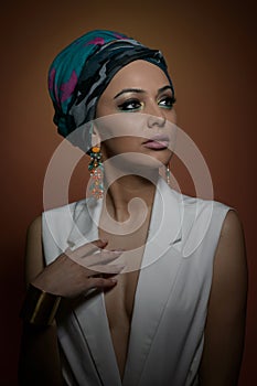 Beautiful woman in a turban.Young beautiful woman with turban and golden accessories