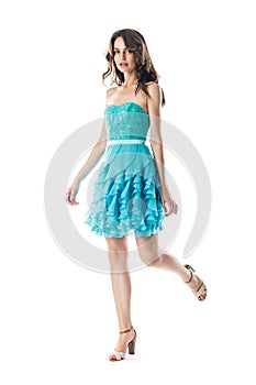 Beautiful woman in turquoise cocktail dress in motion