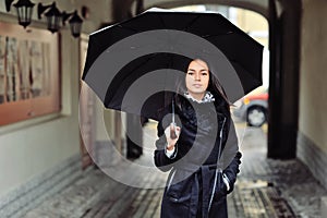 Beautiful woman with umbrella in a rainy weather