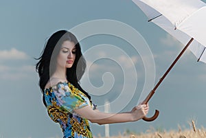 Beautiful woman with umbrella in the Rye