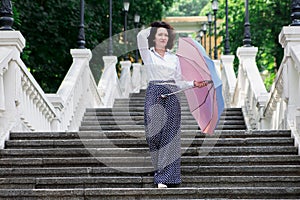 Beautiful woman umbrella urban staircase outdoor park