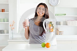 Beautiful woman using a blender