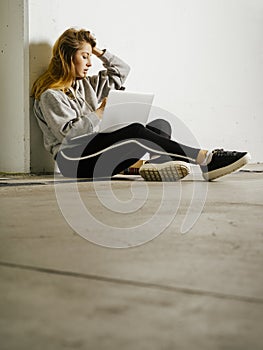 Beautiful woman using her cell phone in school hallway