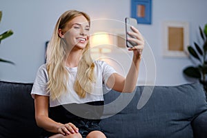 Beautiful woman using her smartphone in the living room