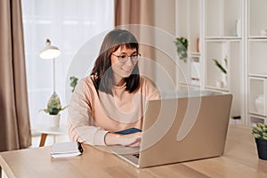 Beautiful woman using laptop for distance learning or remote work