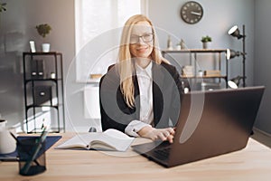 Beautiful woman using laptop for working at business center