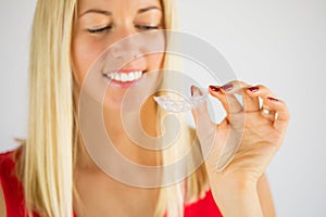 Woman using teeth whitening braces photo