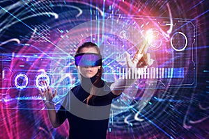 Beautiful woman in virtual reality glasses on a futuristic background.  Augmented reality, game, future technology concept. VR